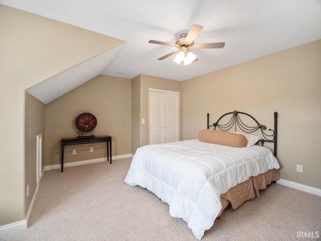 carpeted bedroom featuring ceiling fan, a closet, and lofted ceiling