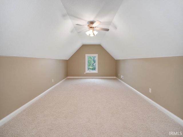 additional living space featuring carpet floors and ceiling fan