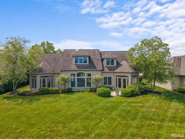 cape cod home featuring a front lawn