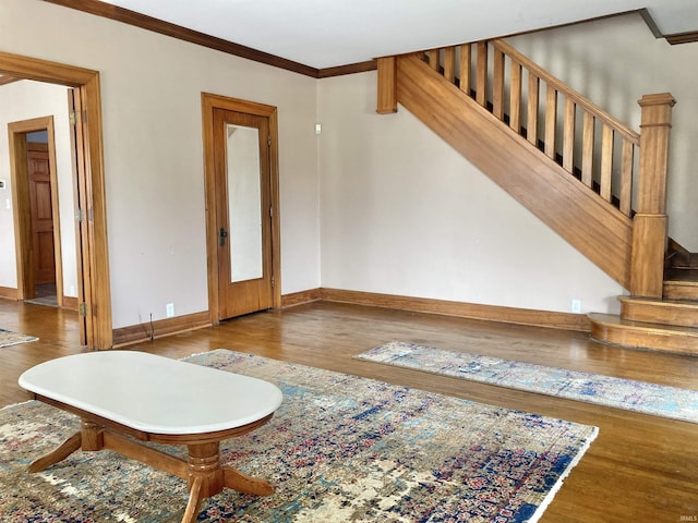 living room featuring ornamental molding and wood-type flooring