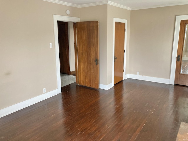 empty room with crown molding and dark wood-type flooring