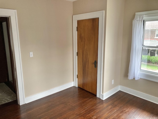 unfurnished bedroom featuring dark hardwood / wood-style floors