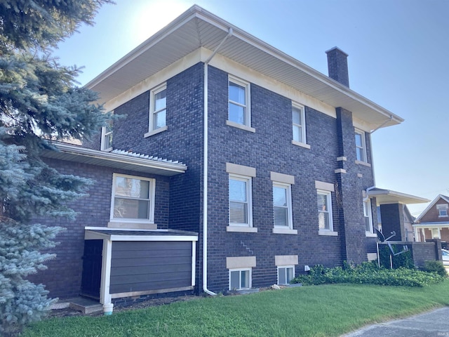 view of side of home with a yard