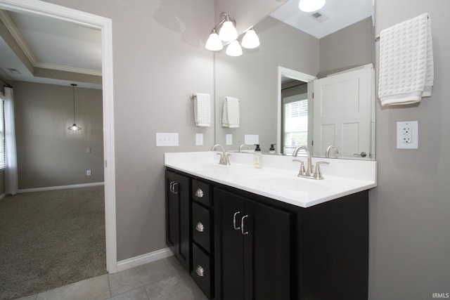 bathroom with tile patterned flooring, ornamental molding, and vanity