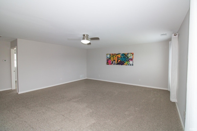 spare room featuring carpet floors and ceiling fan