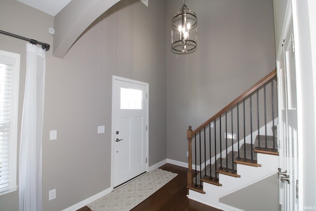 entrance foyer featuring a chandelier and dark hardwood / wood-style flooring