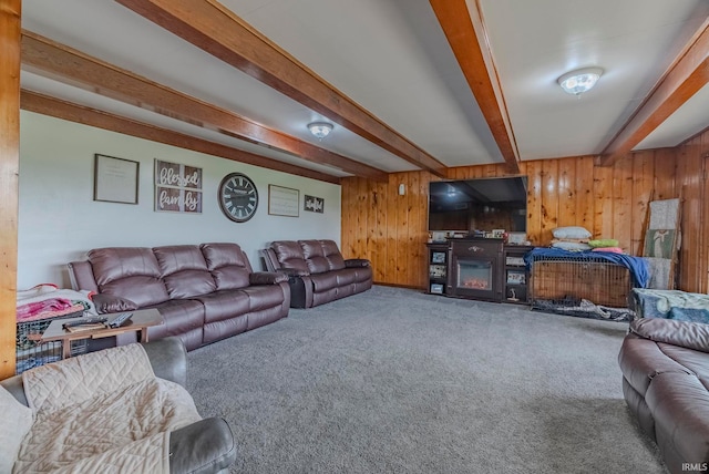 carpeted living room featuring beamed ceiling and wooden walls