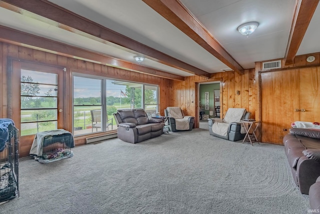 carpeted living room featuring beam ceiling and wood walls