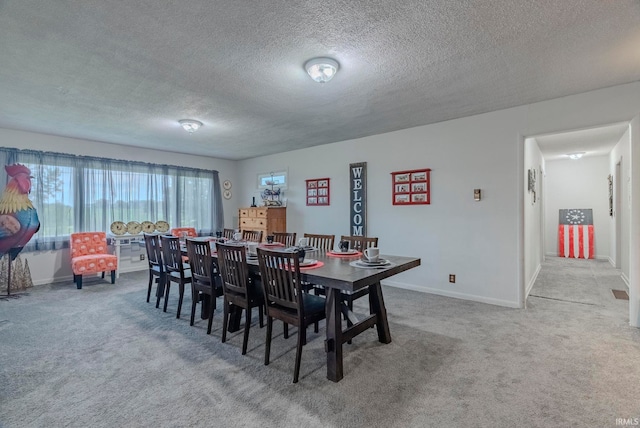 dining room with light carpet and a textured ceiling