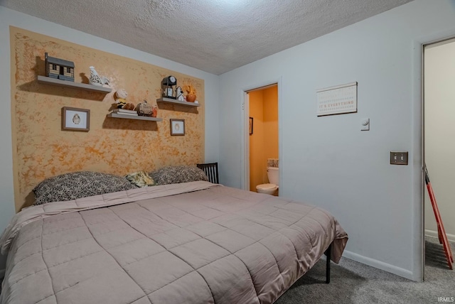 bedroom featuring ensuite bath, carpet flooring, and a textured ceiling