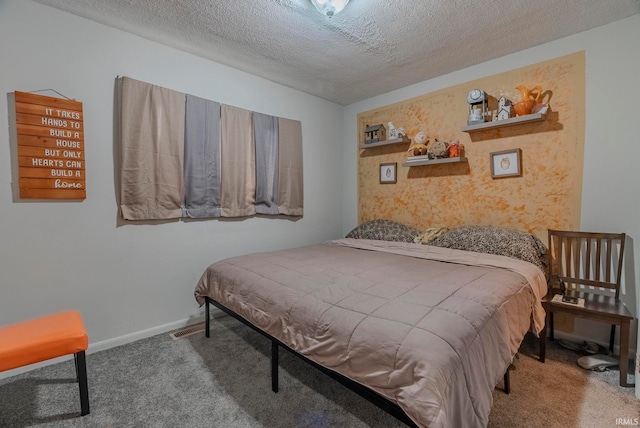 bedroom featuring carpet floors and a textured ceiling