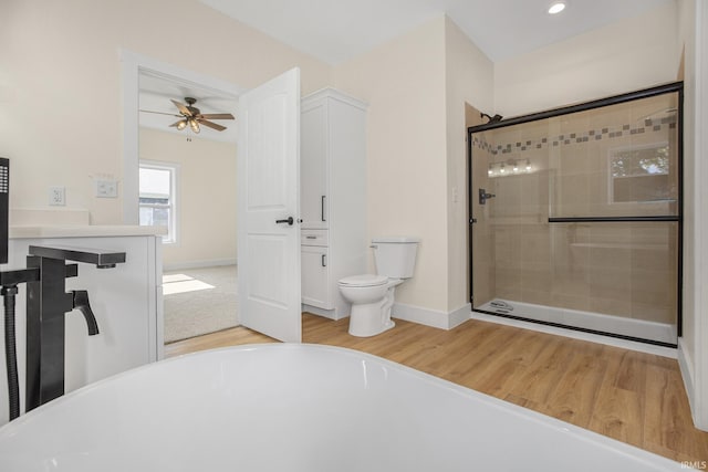 full bathroom with hardwood / wood-style floors, plus walk in shower, toilet, and ceiling fan