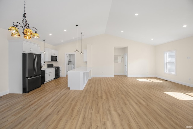 interior space with light hardwood / wood-style floors, vaulted ceiling, and an inviting chandelier