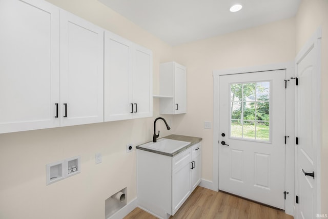 laundry room with light wood-type flooring, sink, electric dryer hookup, cabinets, and washer hookup