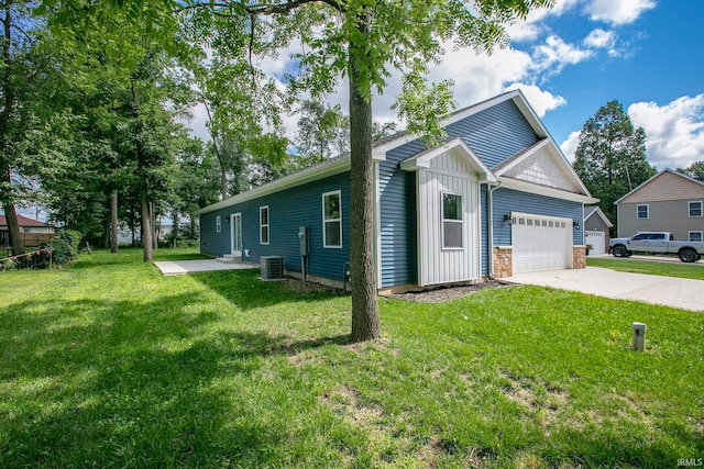 view of property exterior with a garage, a yard, and central AC unit