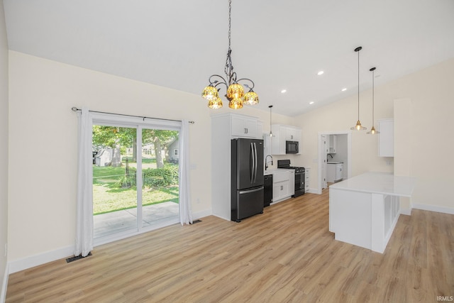 kitchen with light hardwood / wood-style flooring, kitchen peninsula, white cabinets, black appliances, and pendant lighting