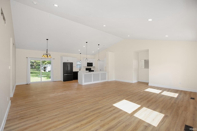 unfurnished living room with light hardwood / wood-style floors and high vaulted ceiling