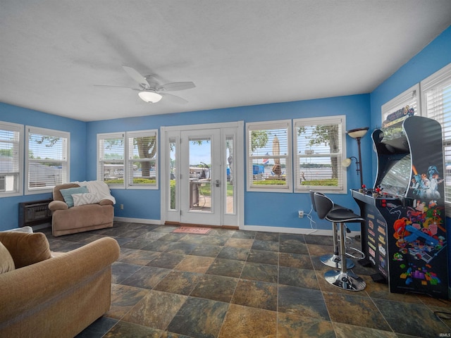 interior space with ceiling fan and plenty of natural light