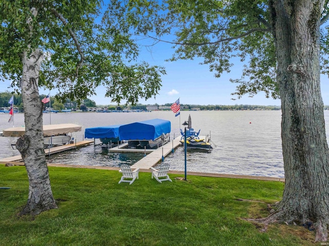 dock area featuring a water view and a lawn