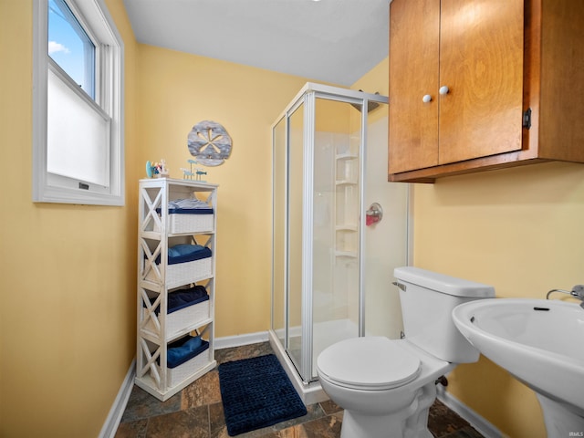 bathroom with toilet, sink, and walk in shower