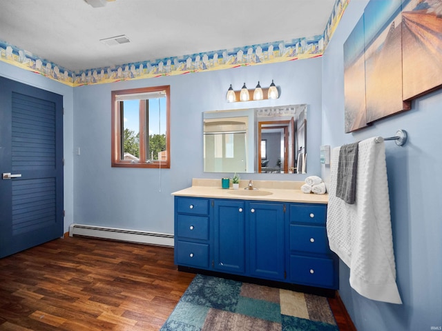 bathroom with walk in shower, wood-type flooring, vanity, and a baseboard radiator