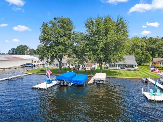 dock area with a water view and a yard