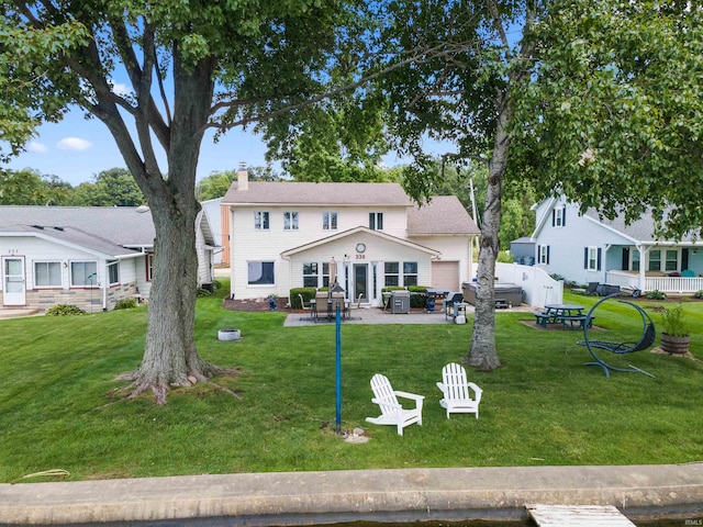 view of front of house featuring a front lawn and a patio area