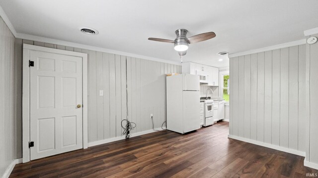 interior space with ceiling fan, crown molding, and dark wood-type flooring