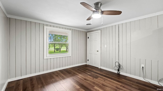 empty room with ceiling fan, hardwood / wood-style flooring, and ornamental molding