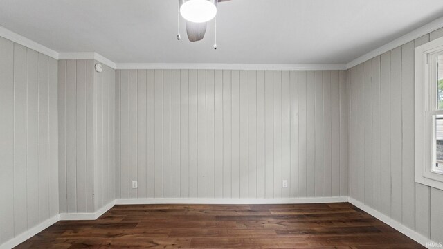 spare room with ornamental molding, ceiling fan, and dark hardwood / wood-style floors