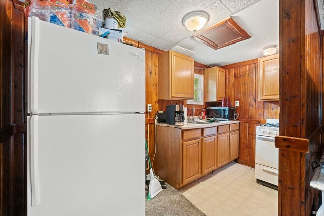 kitchen featuring light tile patterned flooring and white appliances