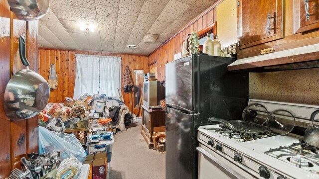 kitchen with wood walls and gas range