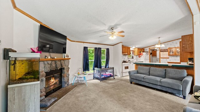 living room featuring lofted ceiling, light colored carpet, a fireplace, and ceiling fan