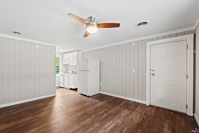 unfurnished living room with ornamental molding, ceiling fan, and hardwood / wood-style floors