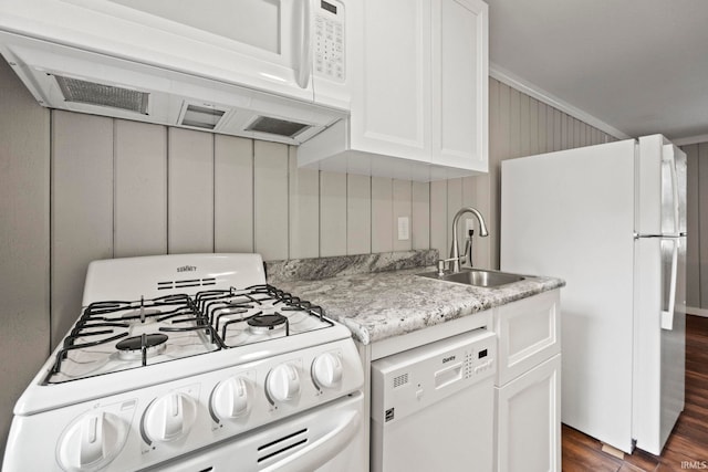 kitchen featuring sink, dark hardwood / wood-style flooring, white cabinetry, and white appliances