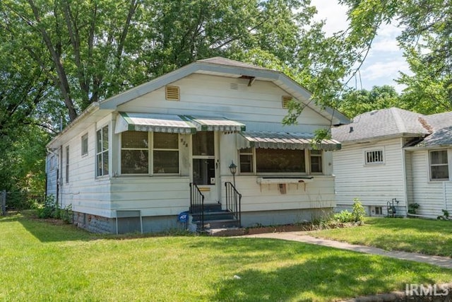 bungalow-style house with a front yard