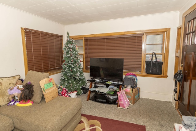 carpeted living room featuring ornamental molding