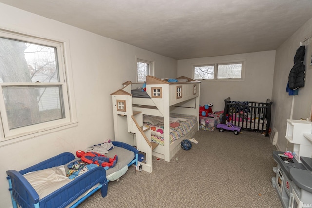 carpeted bedroom with multiple windows