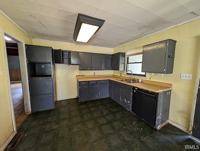 kitchen featuring dishwasher, dark tile patterned flooring, butcher block countertops, sink, and ornamental molding