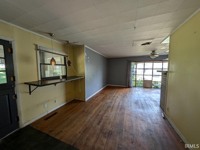 unfurnished living room with ceiling fan, dark hardwood / wood-style floors, and crown molding