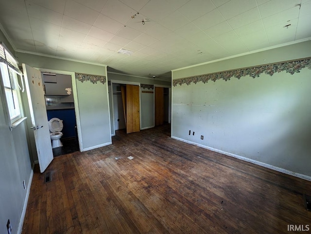 unfurnished bedroom with wood-type flooring, ensuite bathroom, and ornamental molding