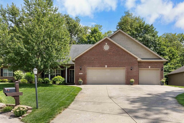 view of front of property featuring a garage and a front lawn