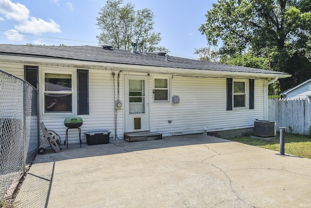 back of house with central AC unit and a patio area