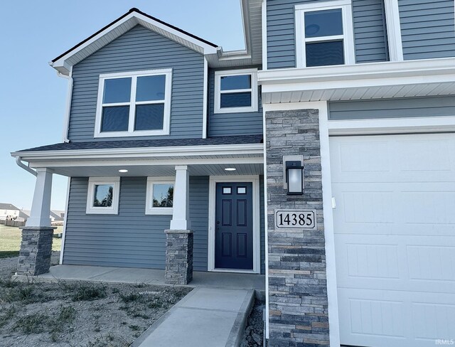 exterior space with a garage and covered porch