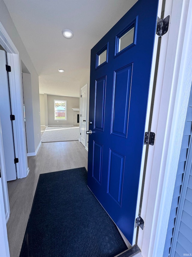 hallway with hardwood / wood-style floors