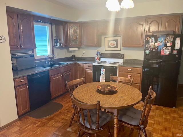 kitchen featuring sink, dark parquet floors, and black appliances