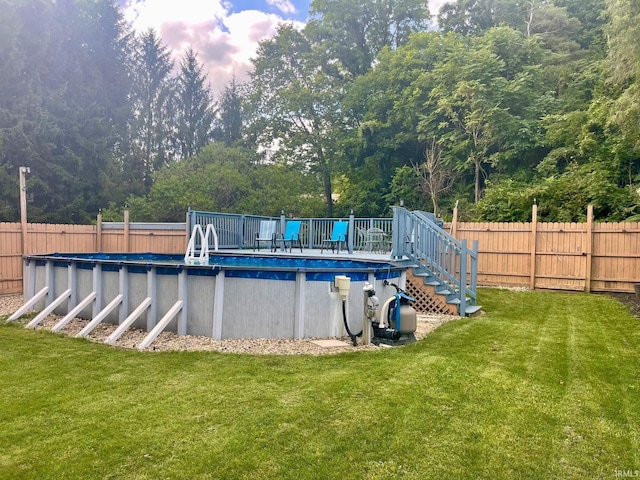 view of swimming pool with a lawn