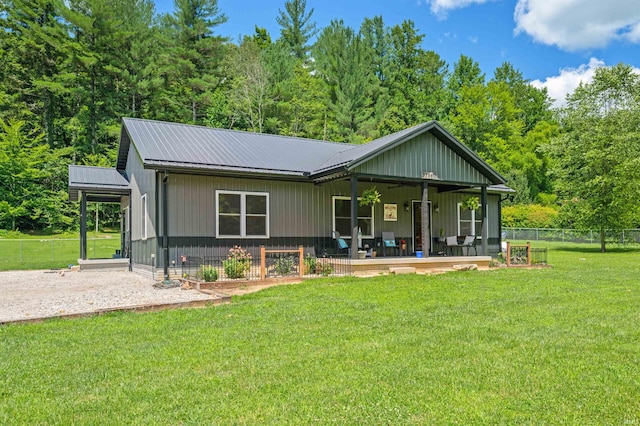 rear view of property with a yard