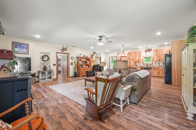 living room with ceiling fan and hardwood / wood-style floors