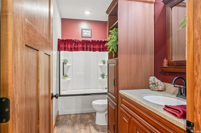 full bathroom with shower / bath combination, vanity, hardwood / wood-style flooring, and toilet